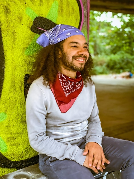 Portrait of smiling young man sitting outdoors