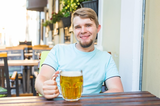 Portrait of a smiling young man sitting in restaurant