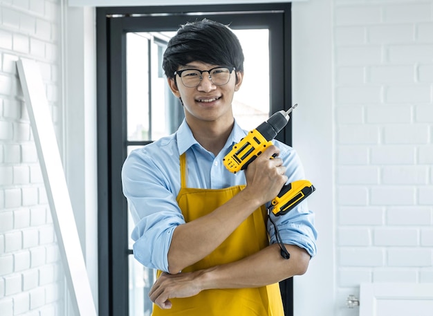 portrait of smiling young man standing against window