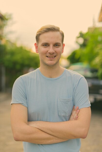 Portrait of smiling young man standing outdoors