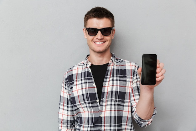 Portrait of a smiling young man in sunglasses