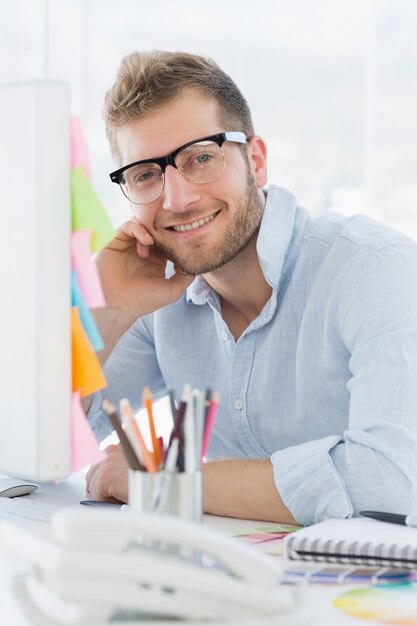 Portrait of a smiling young man using computer