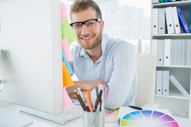 Portrait of a smiling young man using computer