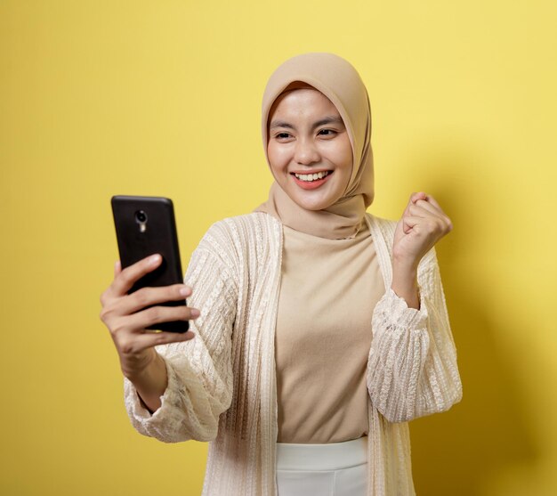 Portrait of smiling young man using mobile phone