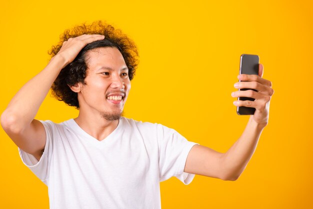 Portrait of smiling young man using mobile phone