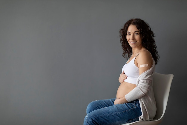 Portrait Of Smiling Young Pregnant Woman Posing After Coronavirus Vaccination