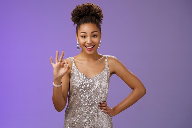 Portrait of a smiling young woman against blue background