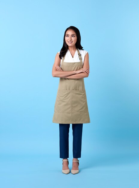 Portrait of a smiling young woman against blue background