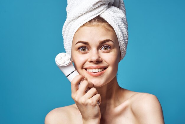 Portrait of a smiling young woman against blue background