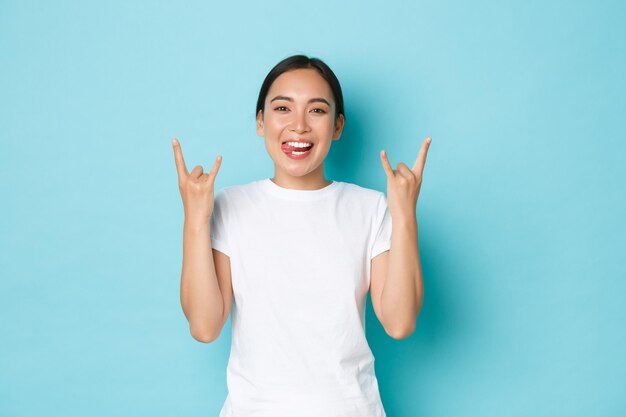 Portrait of a smiling young woman against blue background