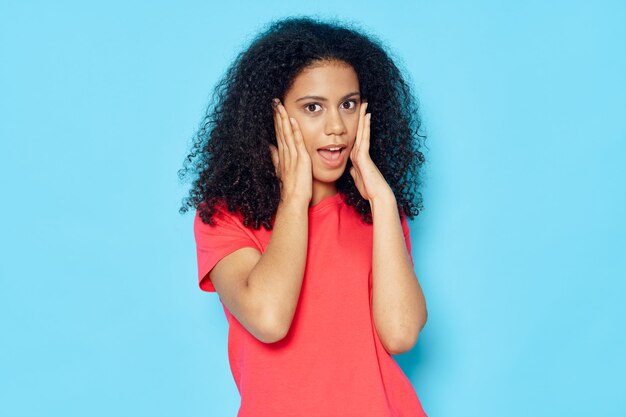 Portrait of a smiling young woman against blue background