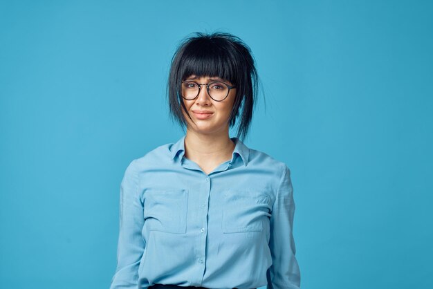 Portrait of a smiling young woman against blue background