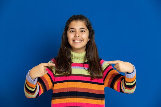 Portrait of a smiling young woman against blue background