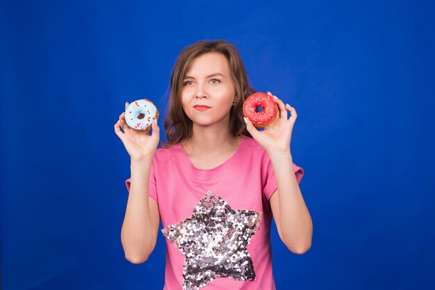 Portrait of a smiling young woman against blue background