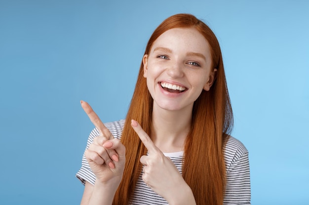 Portrait of a smiling young woman against blue background