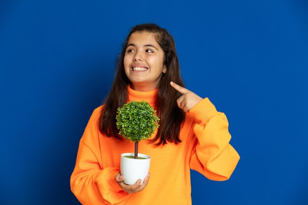 Portrait of a smiling young woman against blue background