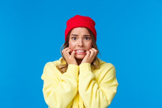 Portrait of a smiling young woman against blue background