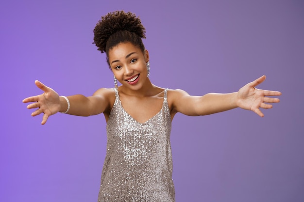 Portrait of smiling young woman against blue background