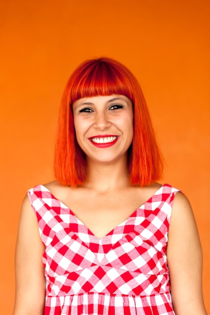 Portrait of smiling young woman against colored background