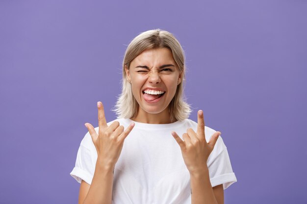 Portrait of a smiling young woman against gray background