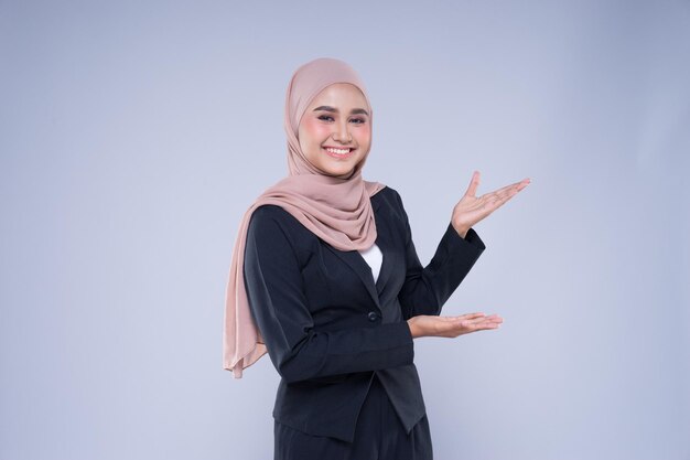 Portrait of a smiling young woman against gray background