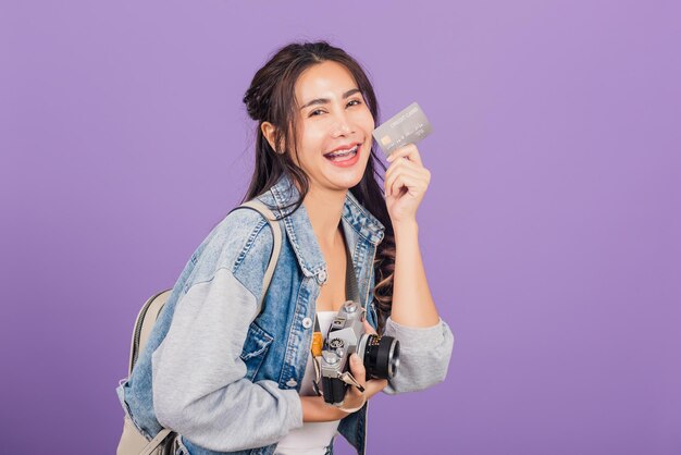 Portrait of a smiling young woman against pink background