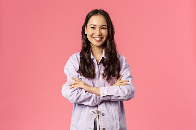 Portrait of a smiling young woman against red background