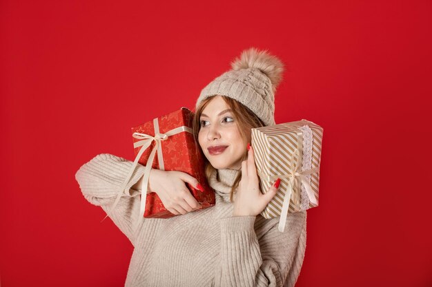 Portrait of smiling young woman against red background