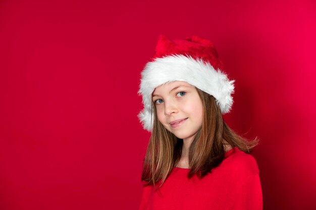 Portrait of a smiling young woman against red background