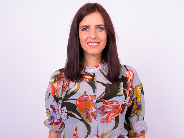 Portrait of smiling young woman against white background