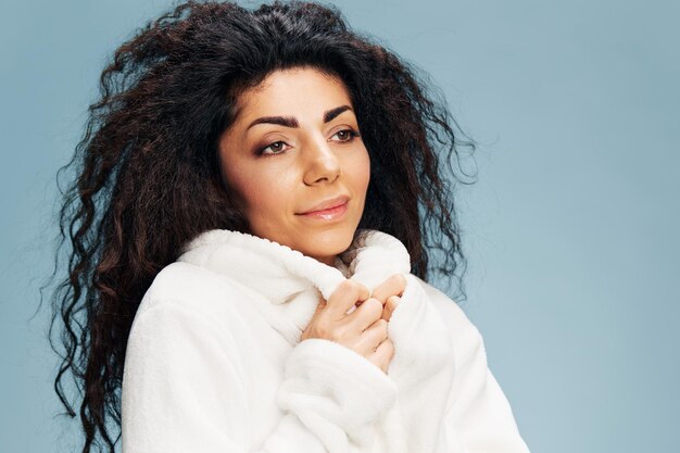 Portrait of smiling young woman against white background