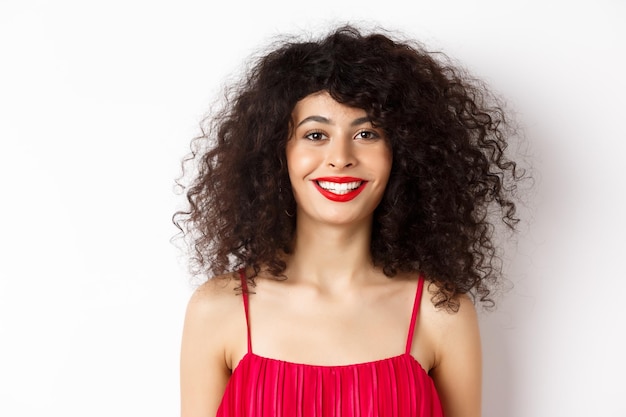 Photo portrait of a smiling young woman against white background