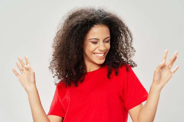 Portrait of smiling young woman against white background