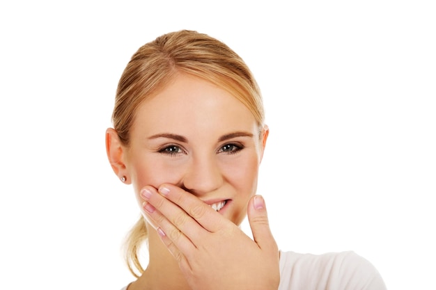 Portrait of smiling young woman against white background