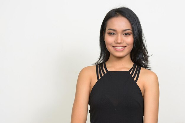 Portrait of a smiling young woman against white background