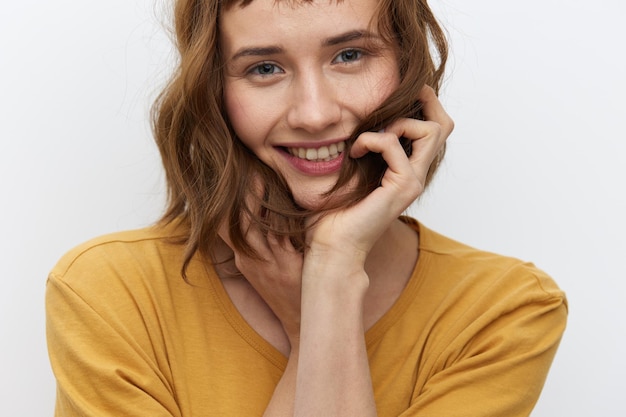 Portrait of smiling young woman against white background