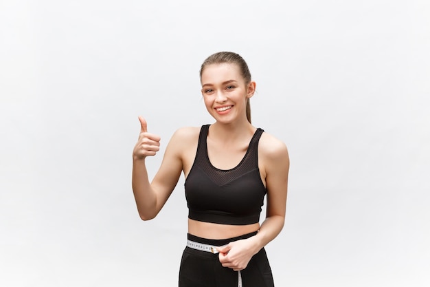 Portrait of smiling young woman against white background