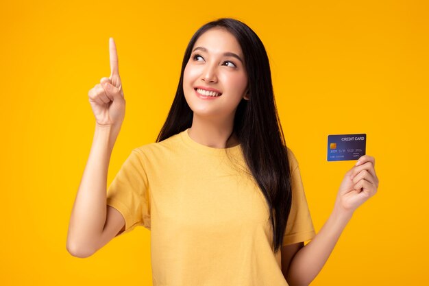 Portrait of a smiling young woman against yellow background