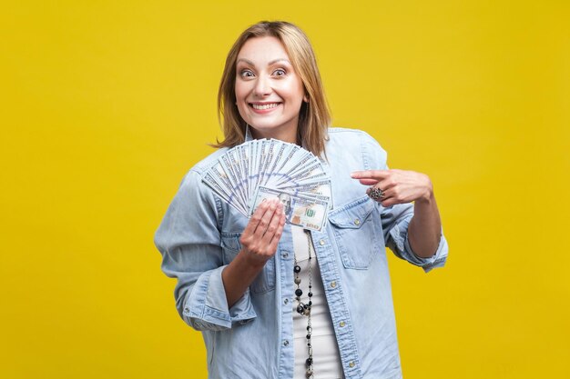 Portrait of a smiling young woman against yellow background