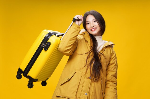 Portrait of a smiling young woman against yellow background