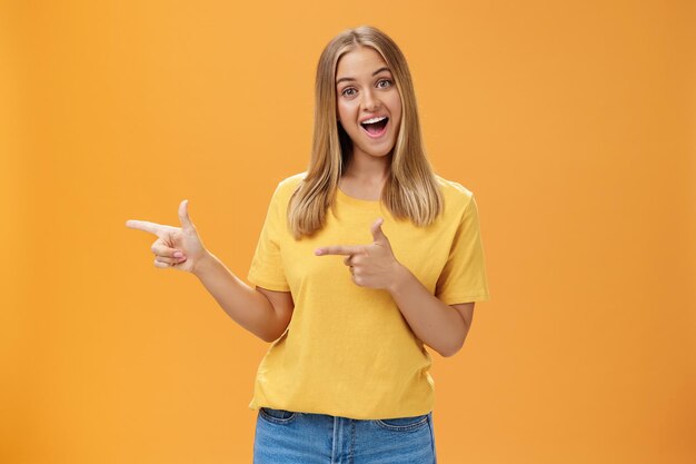 Portrait of a smiling young woman against yellow background