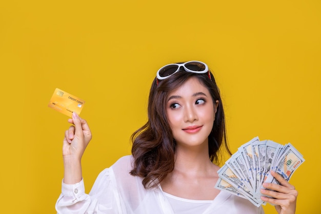 Portrait of a smiling young woman against yellow background