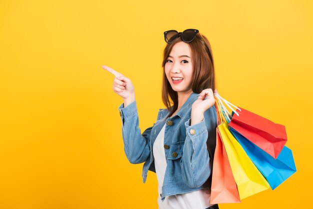 Portrait of a smiling young woman against yellow background