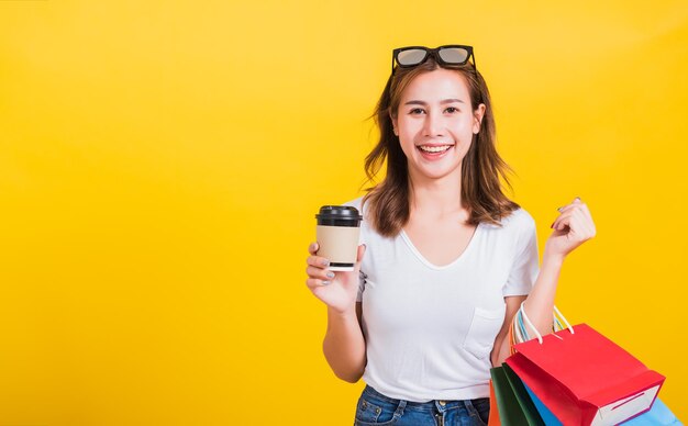 Portrait of a smiling young woman against yellow background