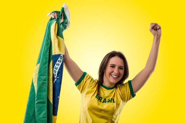 Portrait of a smiling young woman against yellow background