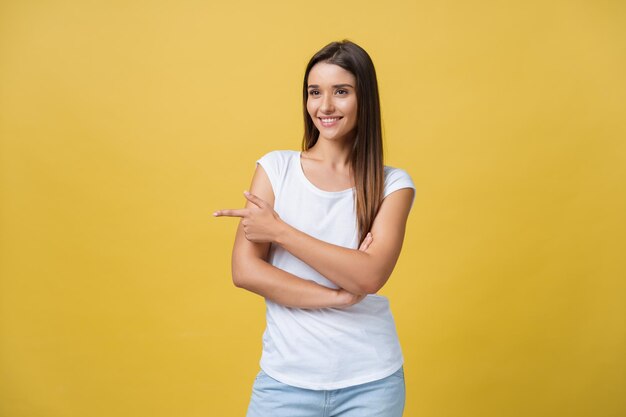 Portrait of a smiling young woman against yellow background