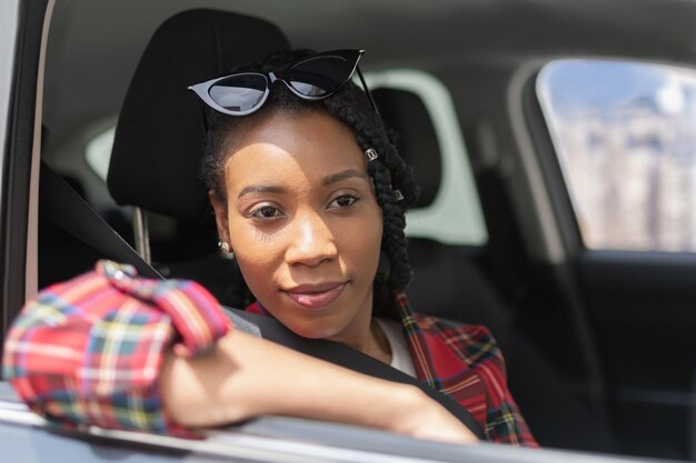 Portrait of a smiling young woman in car