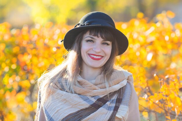 Portrait of smiling young woman during autumn