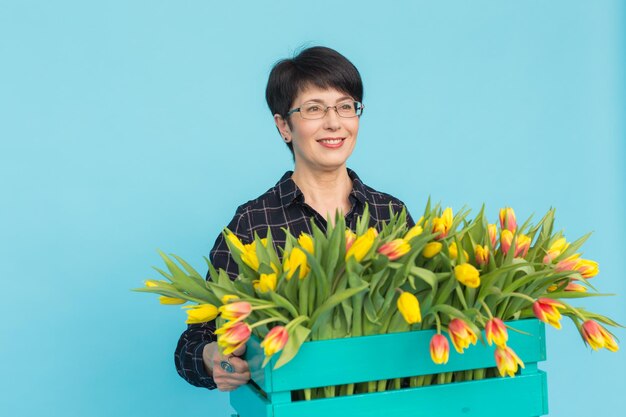 Portrait of smiling young woman holding blue flower