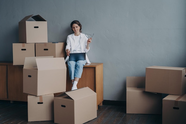 portrait of smiling young woman holding box